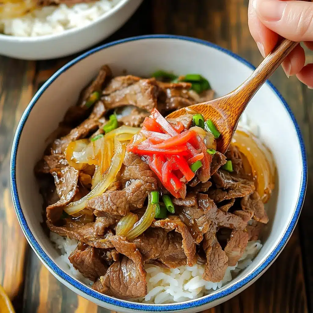 Gyudon Japanese Beef Rice Bowl, Japanese Beef Rice Bowl recipe, authentic Gyudon, quick Japanese dinner, easy Japanese beef bowl A white bowl holds a layered dish starting with a base of steamed rice, topped by thin slices of cooked brown beef mixed with light yellow translucent cooked onions, green onion pieces, and a garnish of bright red pickled ginger strips in the center. A woman's hand holds a wooden spoon lifting a portion of the beef, onions, and rice from the bowl, which has a blue rim. The bowl is placed on a wooden table, and another white bowl with a blue rim and lid appears partly in view.