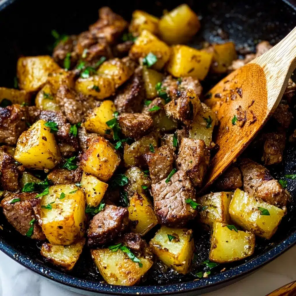 Garlic Butter Steak Bites and Potatoes, garlic butter steak recipe, easy steak dinner, quick potato dish, indulgent weeknight meal The image shows a close-up view of a cooked meat and potato dish in a black pan. The dish has two main layers: the bottom layer consists of golden brown potato chunks with a slightly crispy texture and sprinkled with small green herb pieces. The top layer has browned pieces of meat, also sprinkled with herbs, mixed evenly among the potatoes. Some parts of the potatoes and meat have a light char, giving a darker brown color. A wooden spatula with a warm wood grain texture rests on the right side, partially lifting some of the food. The overall color tones are warm with brown, yellow, and green hues. The pan is set on a white marbled surface.