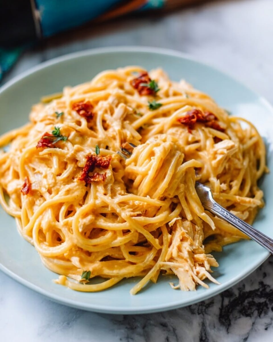 A plate of spaghetti with creamy orange-yellow sauce and small pieces of pinkish-red bacon mixed throughout, showing a rich and smooth texture. The noodles are piled on a white plate, with a silver fork resting on the right side pulling some of the spaghetti. The background is a white marbled surface with a soft natural light highlighting the dish. photo taken with an iphone --ar 4:5 --v 7