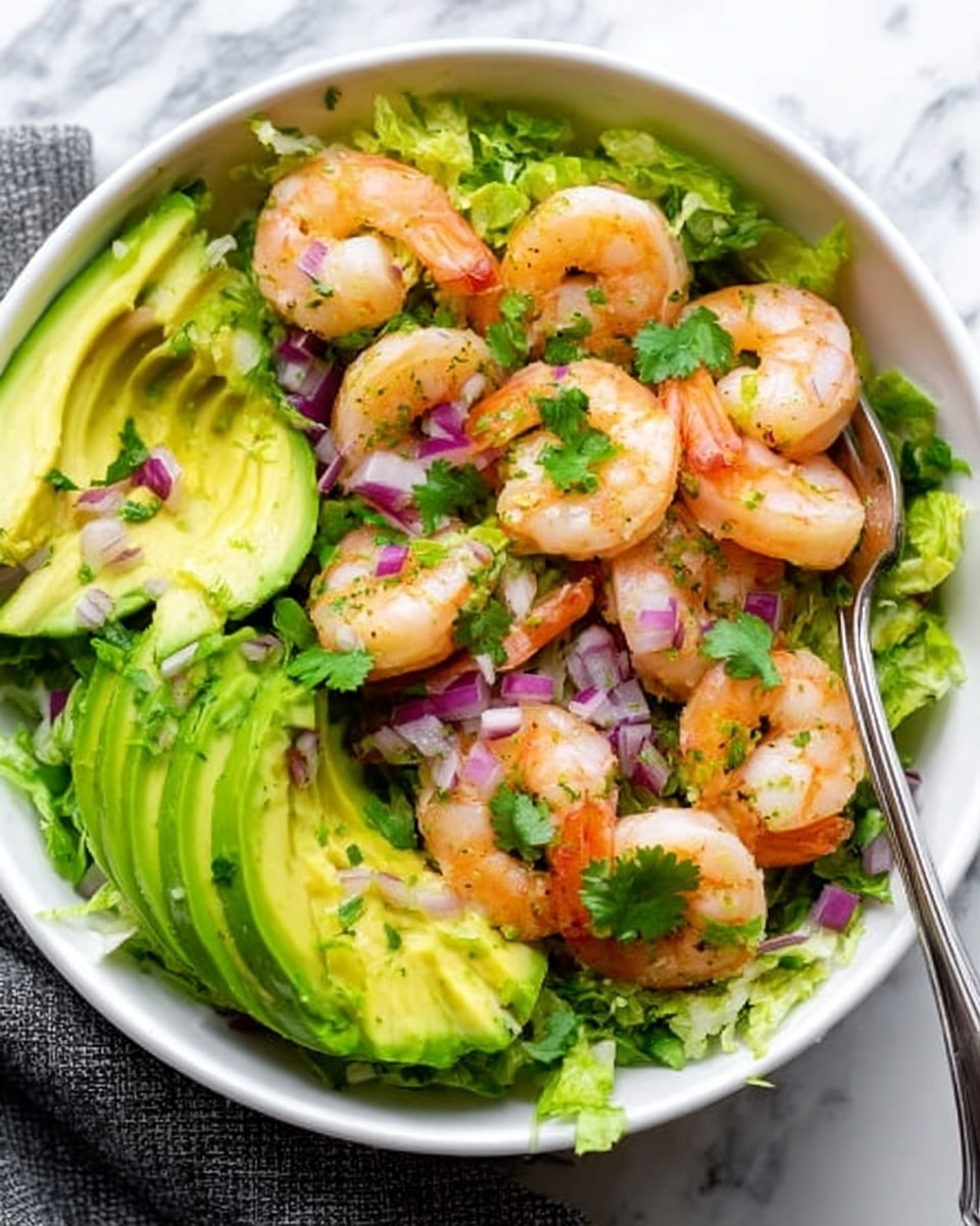 A white bowl filled with a fresh shrimp and avocado salad is shown on a white marbled surface. The bottom layer consists of finely shredded green lettuce that covers the base of the bowl. On top of the lettuce, there are bright green avocado slices arranged in a circular pattern around the bowl. Plump, orange-pink cooked shrimp are placed on and in between the avocado slices, adding a pop of color. Small pieces of diced purple onions and chopped fresh cilantro leaves are scattered over the shrimp and avocado, adding texture and color contrast. A woman's hand is holding a fork inside the bowl near the edge. The photo taken with an iphone --ar 4:5 --v 7