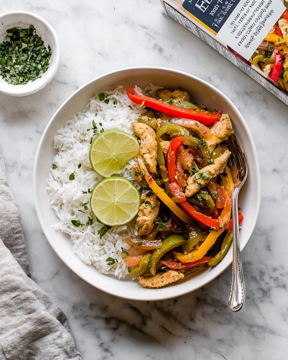 A white bowl holds a layer of fluffy white rice at the bottom. On top, there are strips of cooked turkey with red, yellow, and green bell peppers, and cooked onions mixed in. Two thin lime slices sit on top of the colorful mixture, garnished with small green herb leaves. A silver fork rests inside the bowl on the right side. The bowl is set on a white marbled surface, with a small white bowl of chopped herbs nearby and a meal box partially in view at the top right corner. photo taken with an iphone --ar 4:5 --v 7