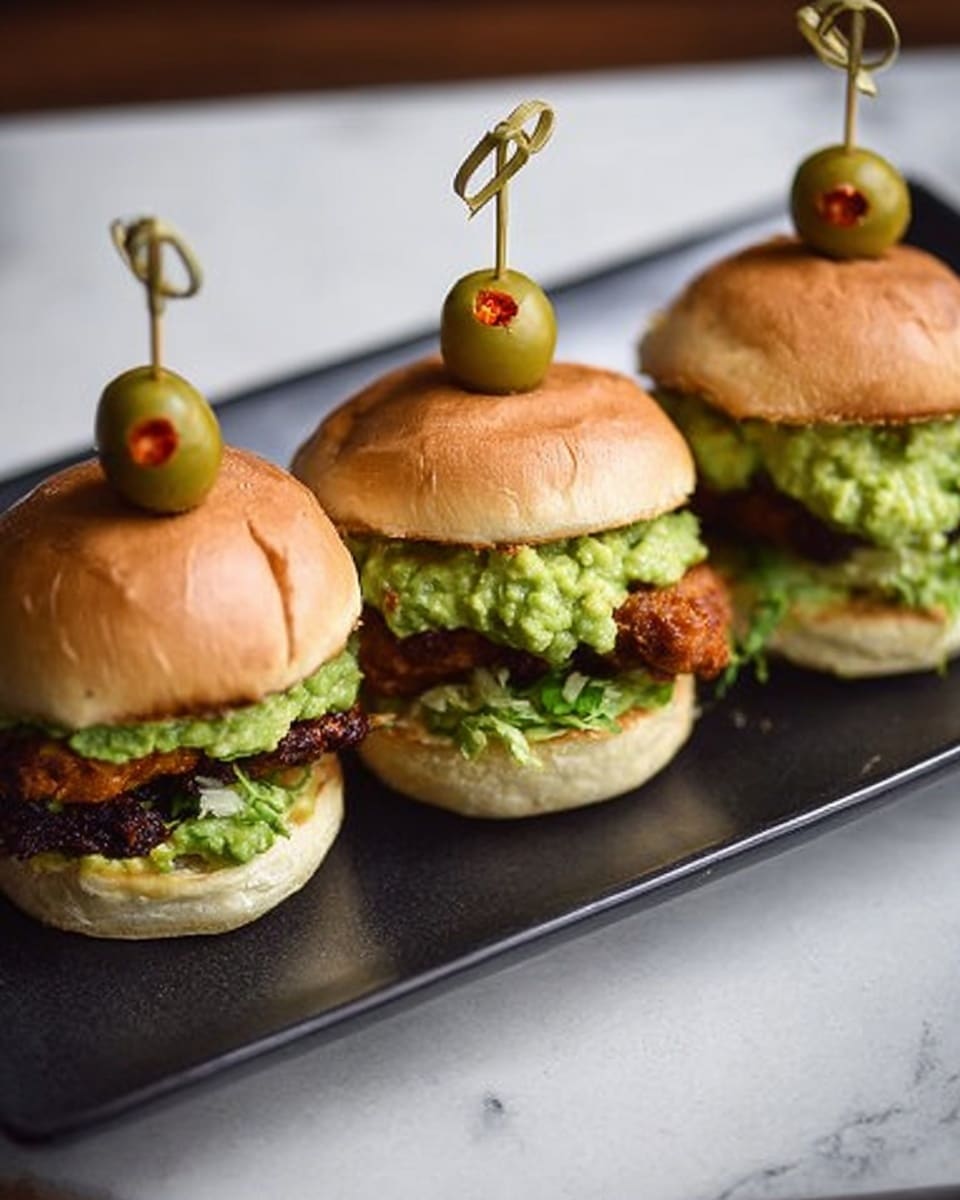 The image shows a grilled patty with dark brown and slightly blackened grill marks placed on the bottom half of a soft, light beige bun. On top of the patty, there is a chunky layer of bright green mashed avocado. The top half of the bun is open and positioned behind the patty, showing its light fluffy inside. The sandwich is on a white plate with thin, light brown lines as decoration, set on a white marbled surface. A woman's hand is holding a metal spoon dropping the avocado onto the patty. Photo taken with an iphone --ar 4:5 --v 7