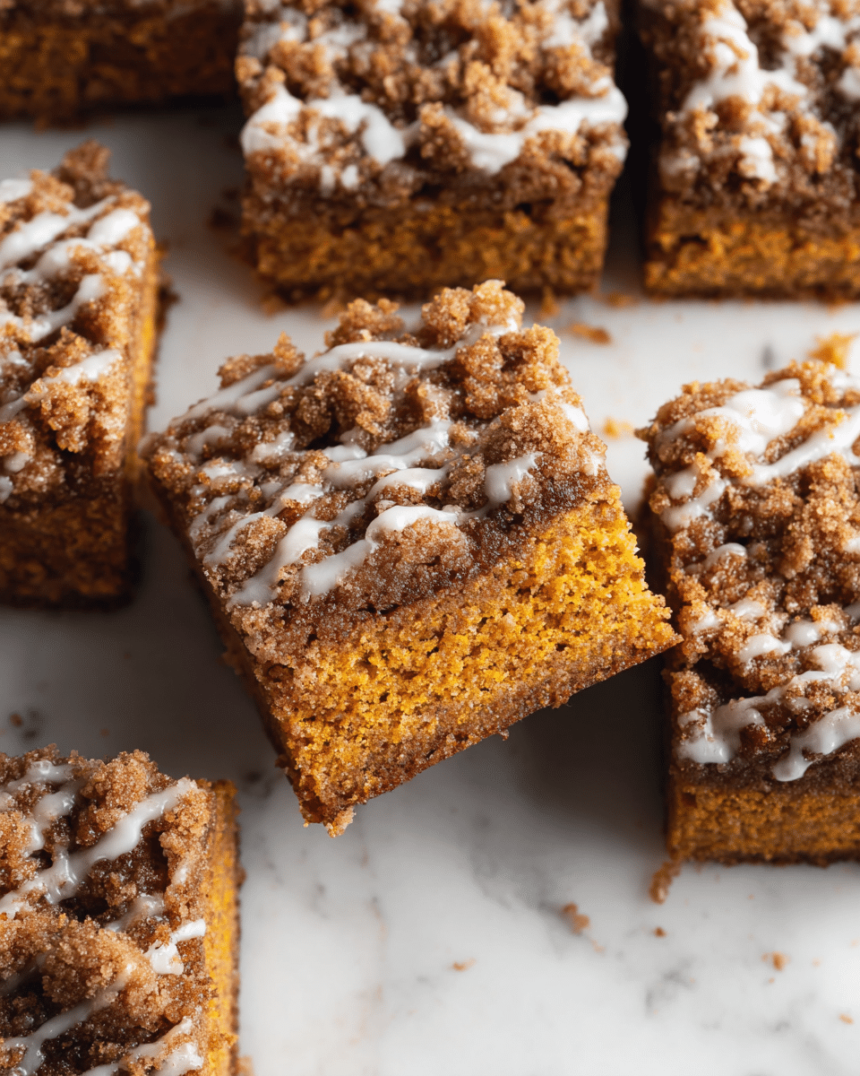 The image shows nine square pieces of crumb cake arranged on white parchment paper on a black cooling rack. Each piece has two layers: a thick, soft golden brown base, with a rough, crumbly dark brown topping that looks crunchy. White glaze is drizzled unevenly on top of the crumb layer, adding a shiny texture. The setup sits on a white marbled surface, and parts of a glass and a utensil are visible around the cake. photo taken with an iphone --ar 4:5 --v 7