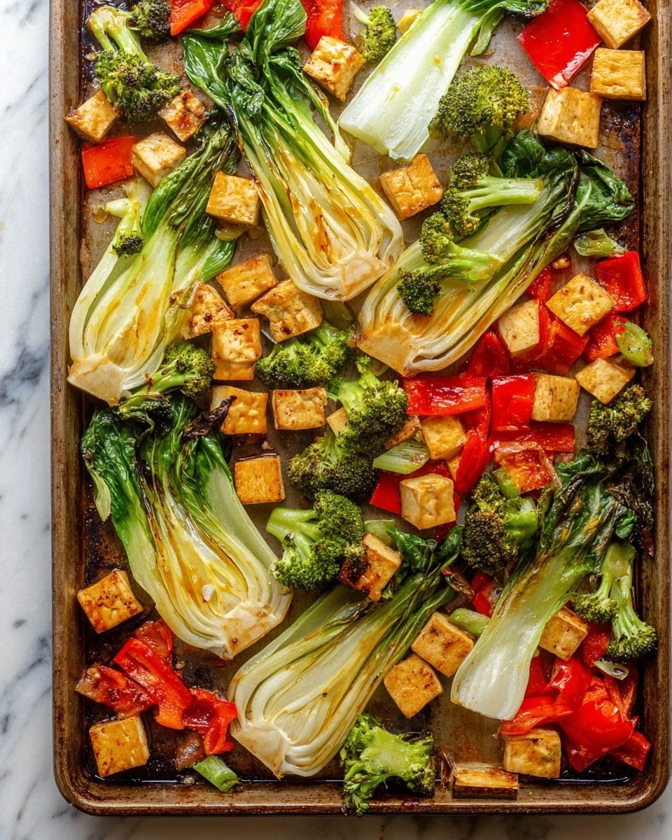 The image shows a baking sheet filled with three main layers of food. The first layer is large pieces of white and green bok choy, spread out diagonally across the sheet with some parts slightly browned. The second layer is small bright green broccoli florets scattered evenly throughout the sheet. The third layer is golden brown tofu cubes placed around the vegetables, with some pieces showing darker grill marks. Red bell pepper chunks are spread around the tofu and vegetables, adding vibrant spots of red color. The whole scene sits on a white marbled surface. photo taken with an iphone --ar 4:5 --v 7