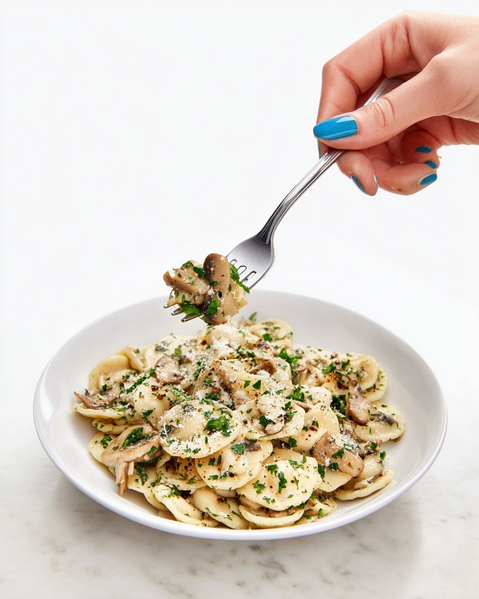 A white plate filled with several layers of lightly cooked sliced mushrooms, each slice showing a soft creamy-beige surface with a slight shine, mixed with small pieces of fresh green parsley scattered evenly across the mushrooms, topped with a sprinkling of finely grated white cheese, all set against a white marbled background photo taken with an iphone --ar 4:5 --v 7