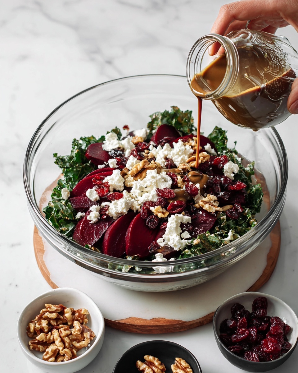 In a clear glass bowl, there is a layered salad starting with dark green leafy kale at the bottom. On top, there are deep red beet slices spread evenly, with white soft cheese dollops scattered around. Light brown walnut pieces and dark red dried cranberries are sprinkled among the cheese and beets, creating a mix of colors and textures. A woman's hand is pouring brown dressing from a small glass jar over the salad. Around the bowl on a white marbled surface, there are three small white and black dishes holding extra walnuts, cranberries, and cheese. Photo taken with an iphone --ar 4:5 --v 7