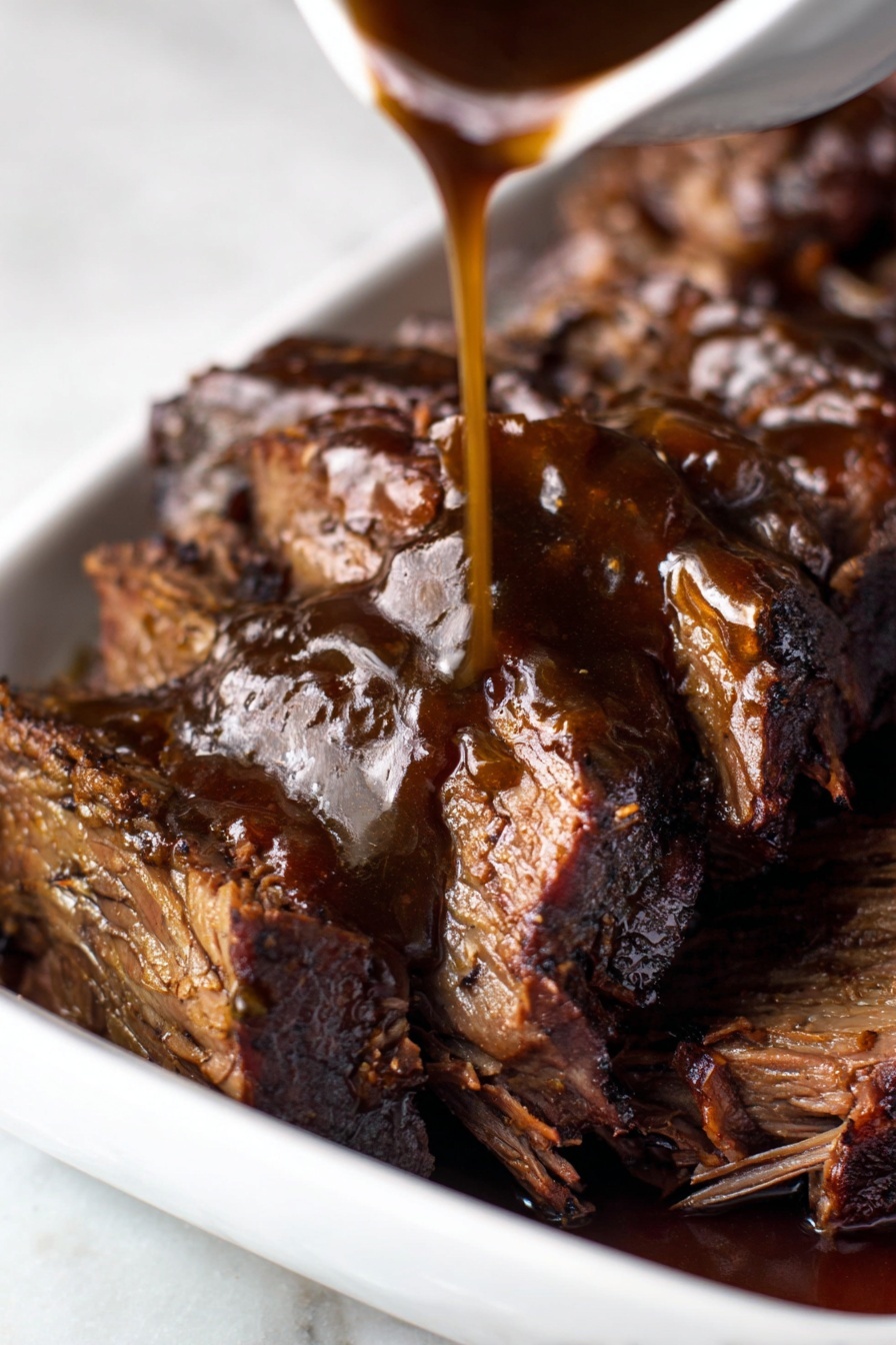 The image shows a close-up of several thick slices of cooked meat with a rich dark brown color and a shiny, moist texture. The meat is arranged in a white dish, with visible fibrous layers and slightly crispy edges. A dark brown sauce is being poured over the top from a sauce container, creating a glossy coating that enhances the meat’s texture and color. The background and surface are a white marbled texture. photo taken with an iphone --ar 2:3 --v 7 - Best Crock Pot Chuck Roast, easy slow cooker beef roast, tender crock pot dinner, hearty beef recipes, simple crock pot meals