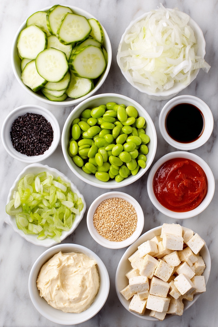 Flat lay of a whole fresh cucumber sliced into thin rounds, a small white ceramic bowl of thinly sliced white onion, a generous handful of golden crispy baked tofu cubes, a small white bowl filled with shelled bright green edamame, a white bowl with thin julienned orange carrot sticks, a small pile of sliced green spring onion, neatly cubed half avocado with vibrant green flesh, a small white bowl containing creamy vegan cream cheese, another small white bowl holding smooth vegan mayo, a small white bowl with bright red Sriracha sauce, a tiny white bowl filled with glossy chili-crisp oil, a small white bowl of dark soy sauce, a small white bowl scattered with light tan sesame seeds, and a small white bowl with delicate dark green crushed nori flakes, all perfectly arranged in balanced symmetry on a clean white marble surface, soft natural light, photo taken with an iPhone, professional food photography style, fresh ingredients, white ceramic bowls, no bottles, no duplicates, no utensils, no packaging --ar 2:3 --v 7 --p m7354615311229779997 - Creamy Asian Cucumber Salad Bowl, Asian cucumber salad, refreshing cucumber salad, quick healthy lunch, Asian-inspired salad